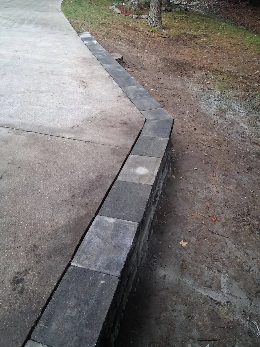 Completed retaining wall supporting a raised driveway edge