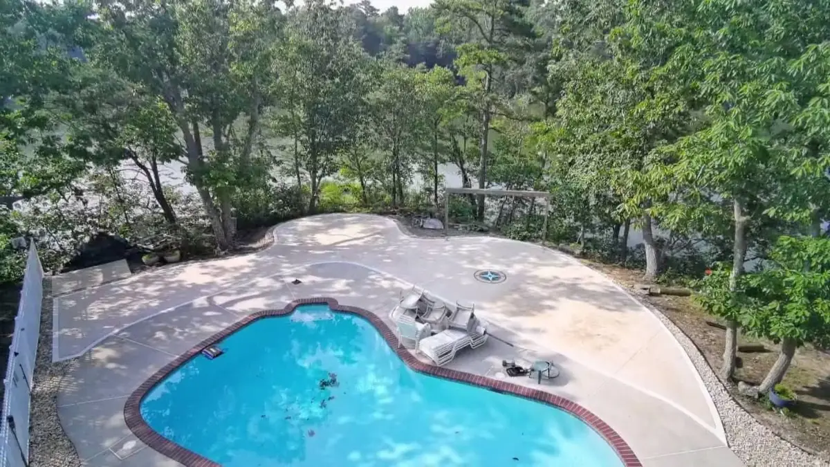 Completed decorative concrete pool deck with a custom compass inlay